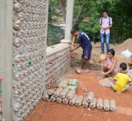 A diario la familia santafé arias llena las botellas plásticas de arena y termina de levantar los muros plásticos para terminar rápidamente su vivienda ecológica. Rodrigo Sandoval