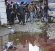 Un grupo de iraquíes se reúne en el lugar del doble ataque suicida en un concurrido mercado del centro de Bagdad. El grupo extremista Estado Islámico se atribuyó la autoría de las explosiones. AP