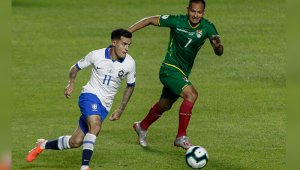 El brasileño Philippe Coutinho (L) está marcado por el boliviano Leonel Justiniano durante su partido de torneo de fútbol de la Copa América en el estadio Cicero Pompeu de Toledo. AFP