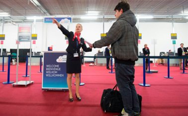 Un empleado de la Aerolínea Brussels informa a un pasajero en una zona de registro temporal, este 3 de abril en el aeropuerto de Bruselas en Zaventem, en su día de reapertura. AFP