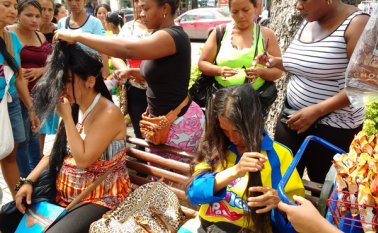 En pleno parque Santander, las mujeres cortan el cabello de sus clientes. Entre 7 y 8 mechones son retirados de sus cabezas.  Rodrigo Sandoval