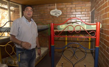 El secretario de Gobierno de Cúcuta, Óscar Gerardino, muestra una de las habitaciones habilitadas para los menores en el hogar de paso. Archivo