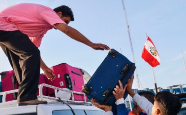 Los venezolanos cargan los vehículos que los transportarán a las estaciones de autobuses cercanas a Tumbes luego de ser autorizados para ingresar a Perú en el Centro Binacional de Atención Fronteriza (CEBAF) en Tumbes, al norte de Perú, en la frontera con Ecuador.  AFP
