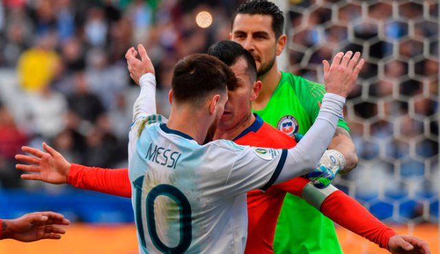 A 10 minutos para el descanso, Messi y Medel lucharon por un balón que se perdía por la línea de fondo. AFP