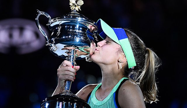 Sofía Kenin besa la Daphne Akhurst Memorial Cup después de ganar contra la española Garbine Muguruza en la final del Abierto de Australia. AFP
