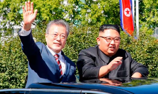 El líder norcoreano Kim Jong-Un (derecha) y el presidente surcoreano Moon Jae-in saludan a los ciudadanos de Pyongyang desde un vehículo. AFP