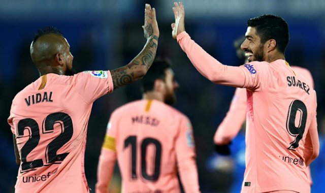 El astro uruguayo del Barcelona Luis Suárez festeja su gol con el chileno Arturo Vidal. AFP